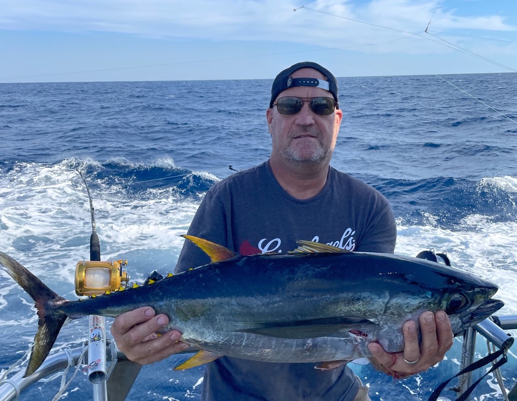 a man holding a fish in the water