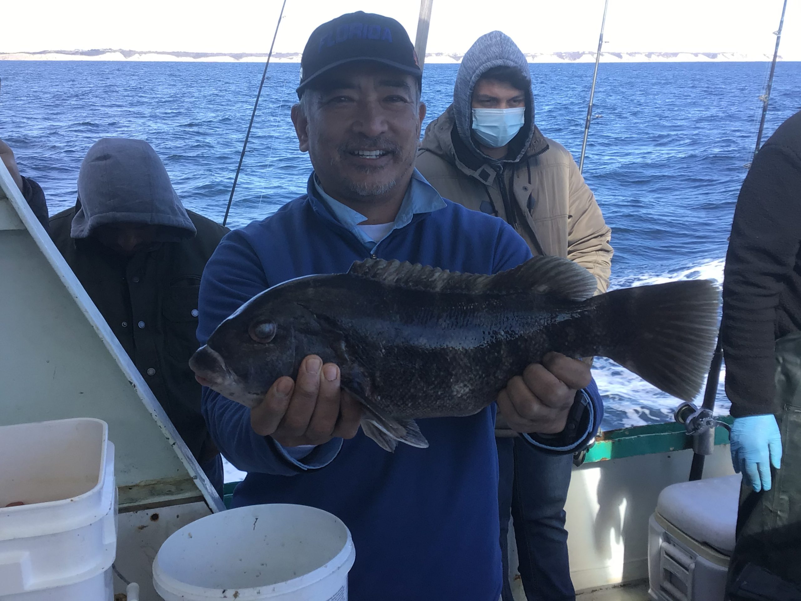 a person holding a fish on a boat