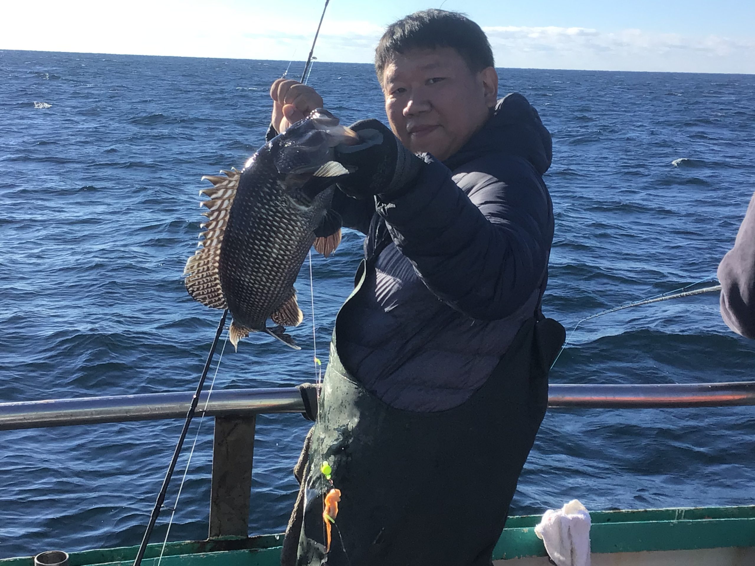 a person standing next to a body of water