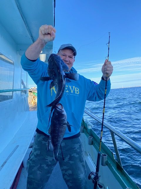 a man holding a fish in the water