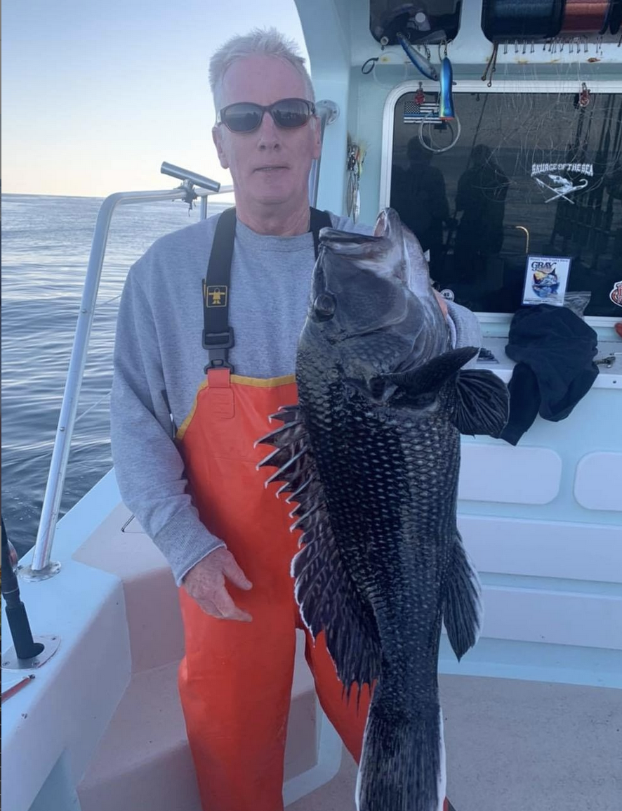 a person holding a fish in the water