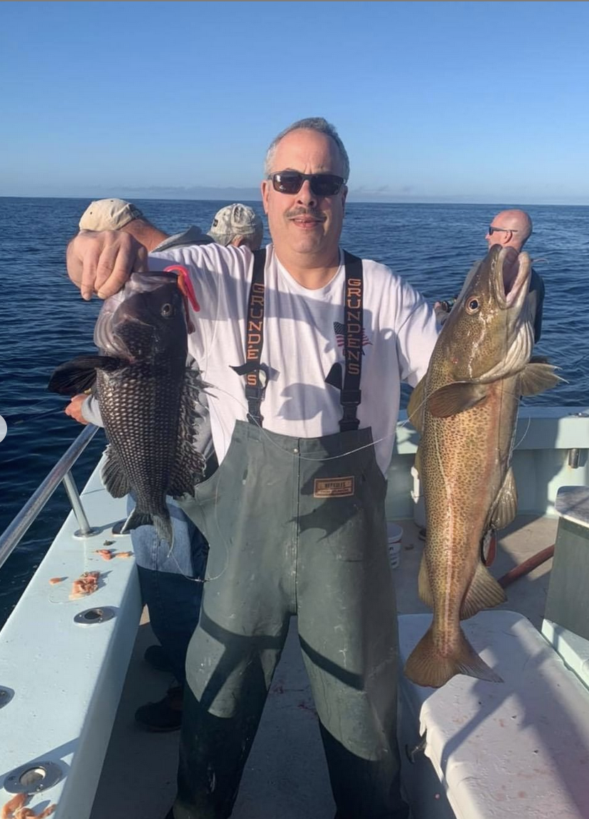 a man holding a fish in the water