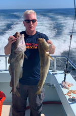 a man holding a fish in the water