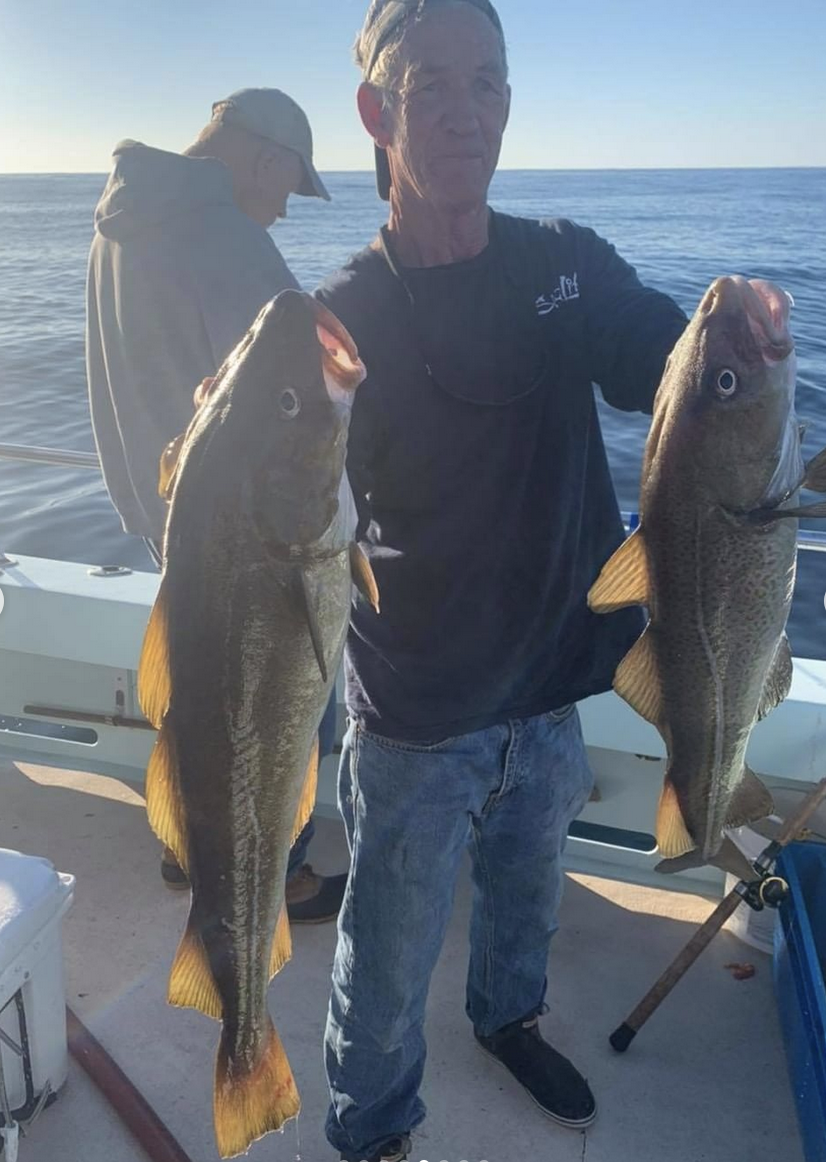 a man holding a fish in the water