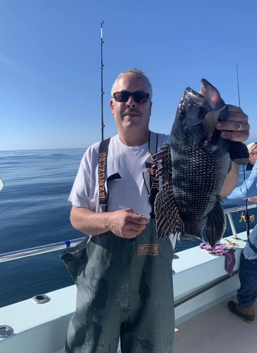 a man holding a fish