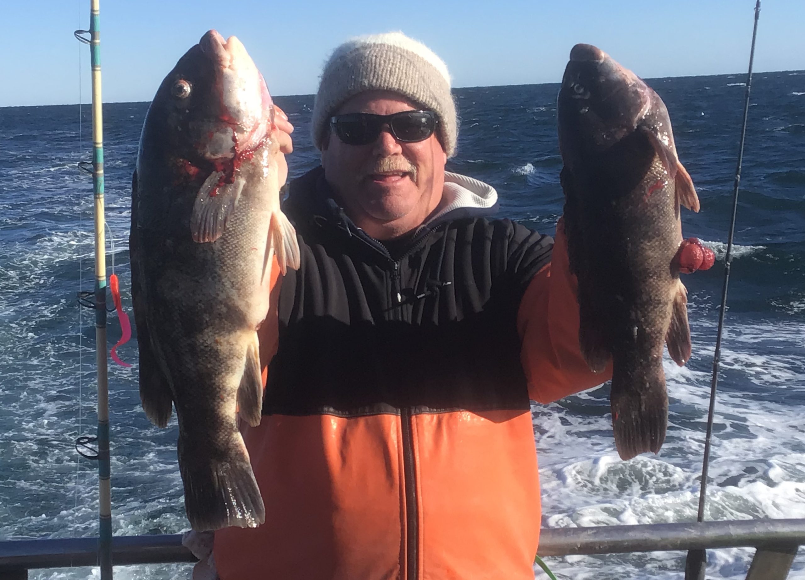 a man holding a fish in the water