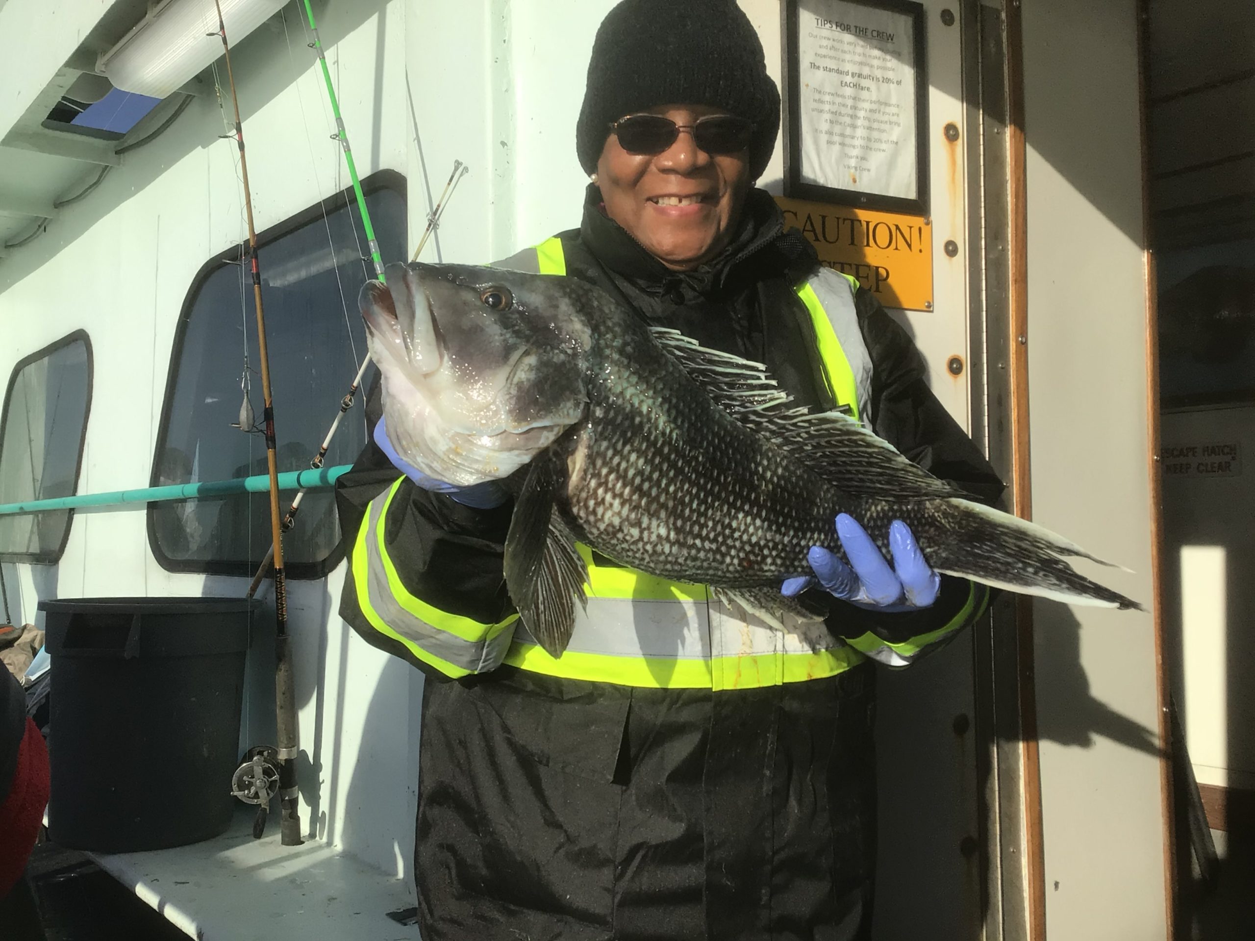 a person wearing a hat and sunglasses posing for the camera