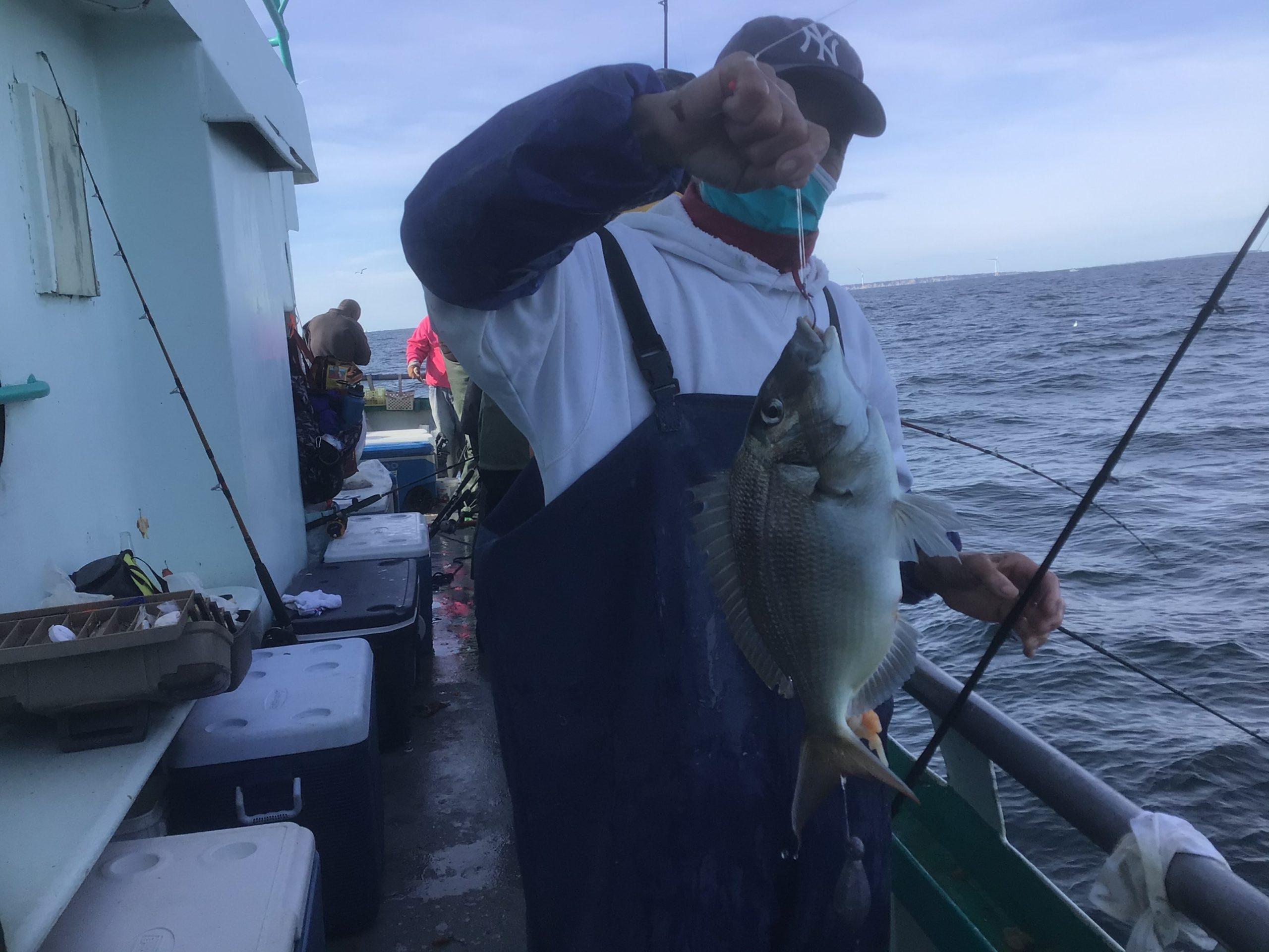 a person holding a fish on a boat