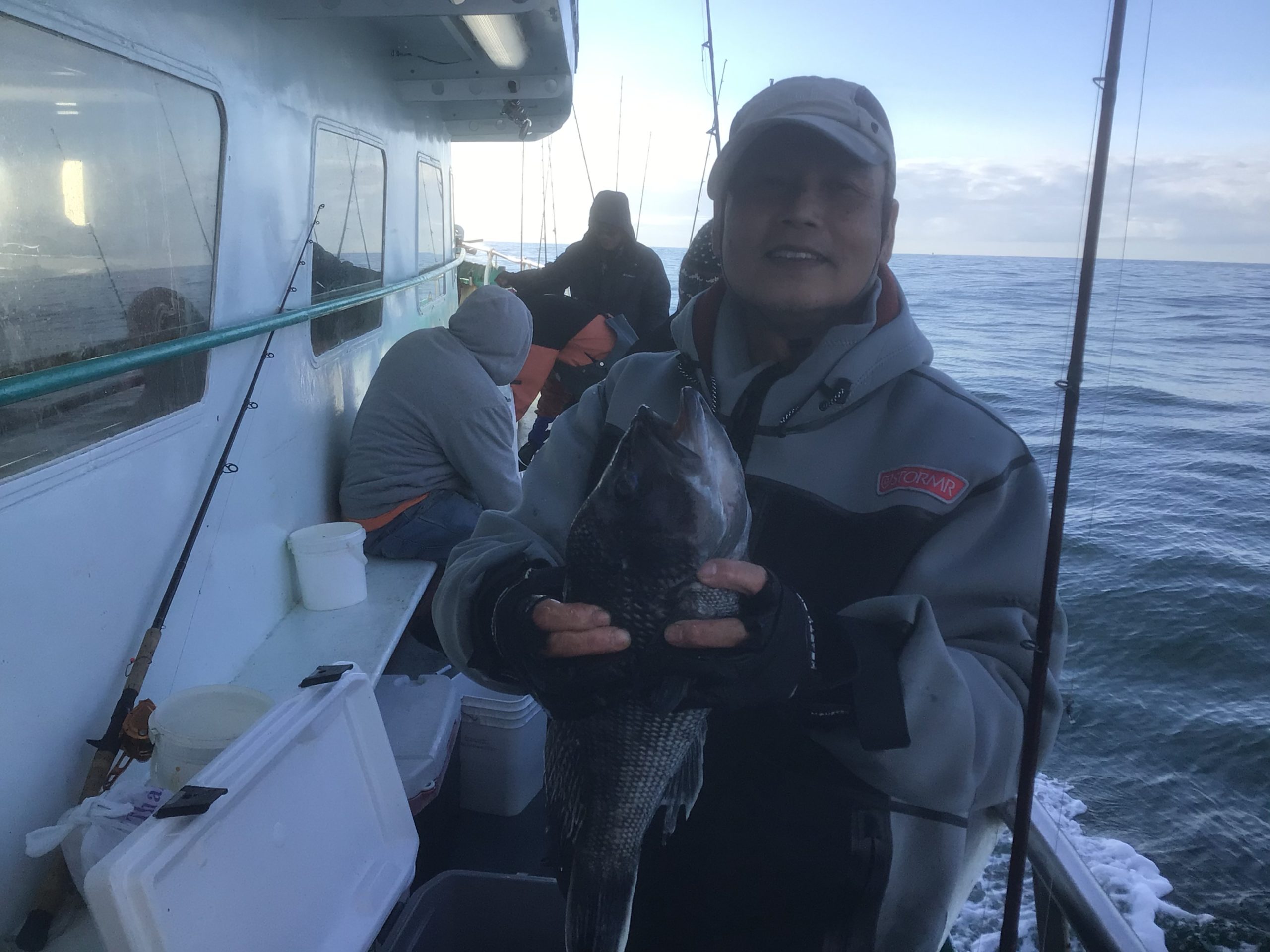 a person holding a fish on a boat