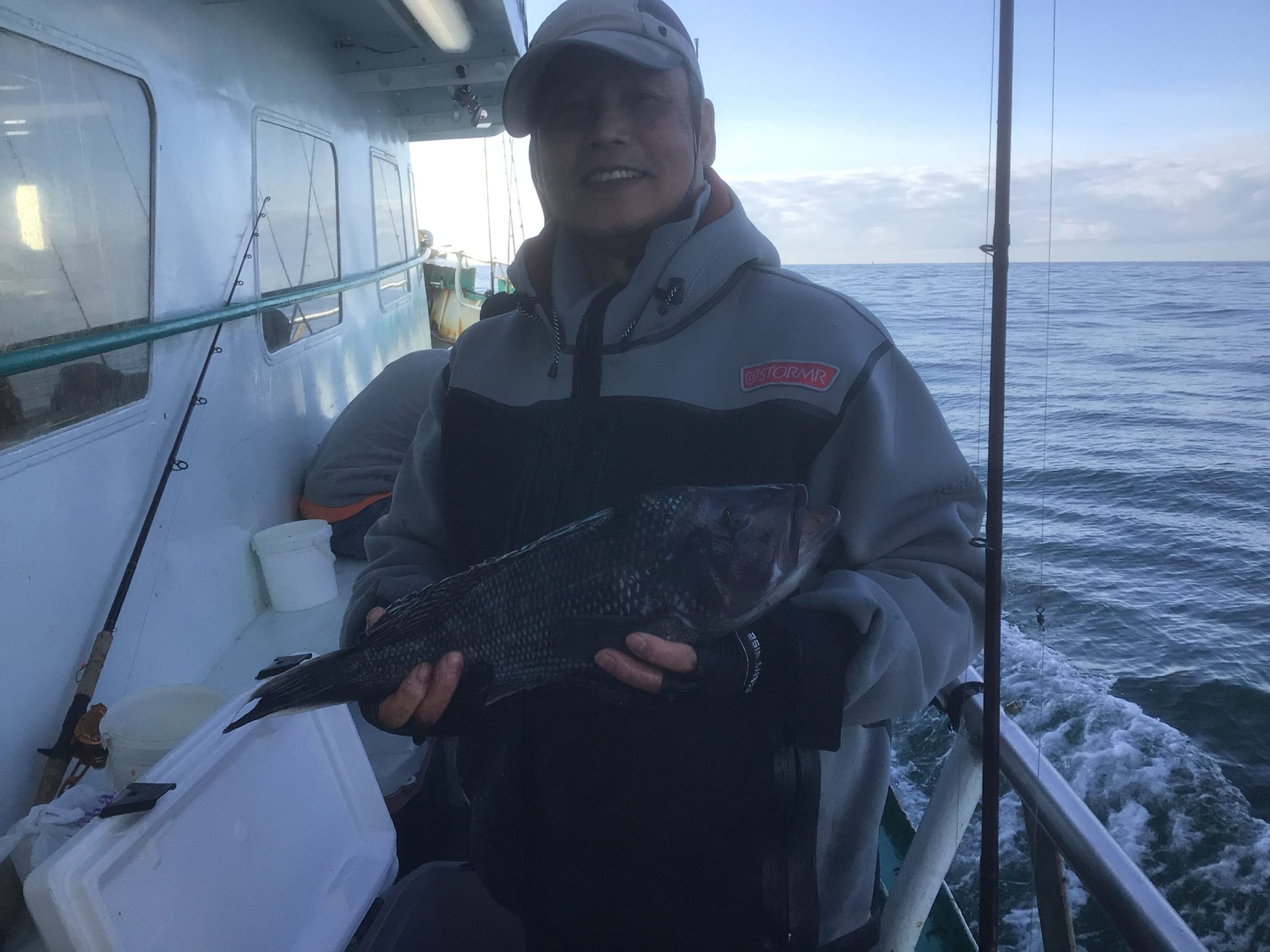 a man sitting on a boat in the water