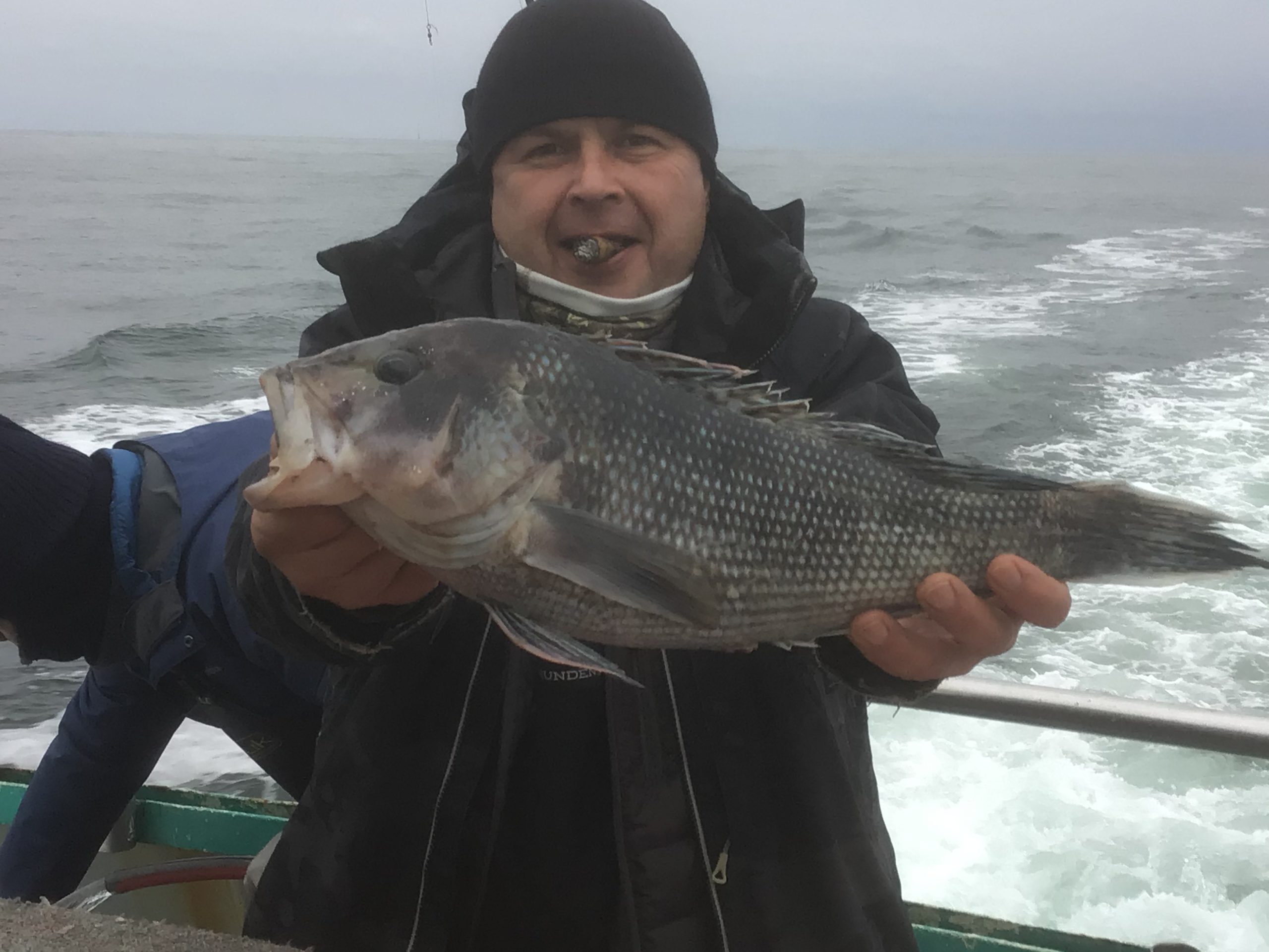 a man holding a fish in the water