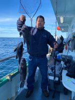 a man holding a fish in the water