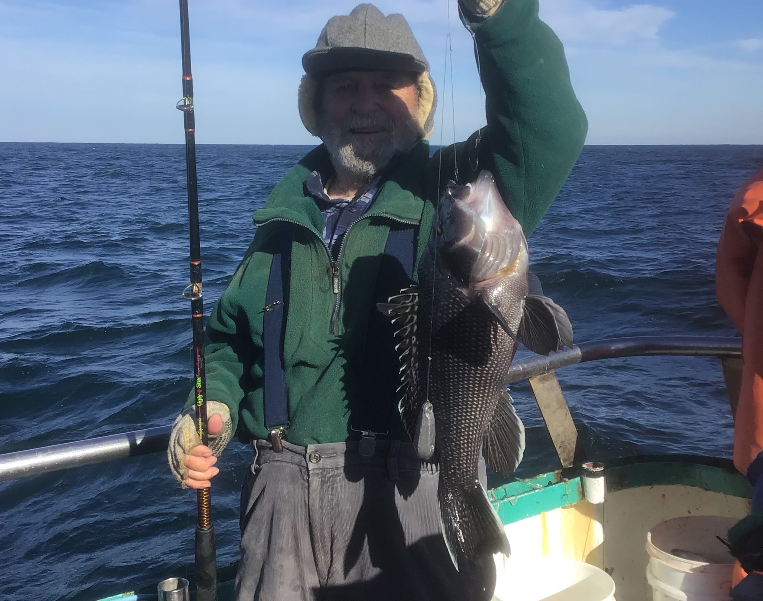a person standing next to a body of water