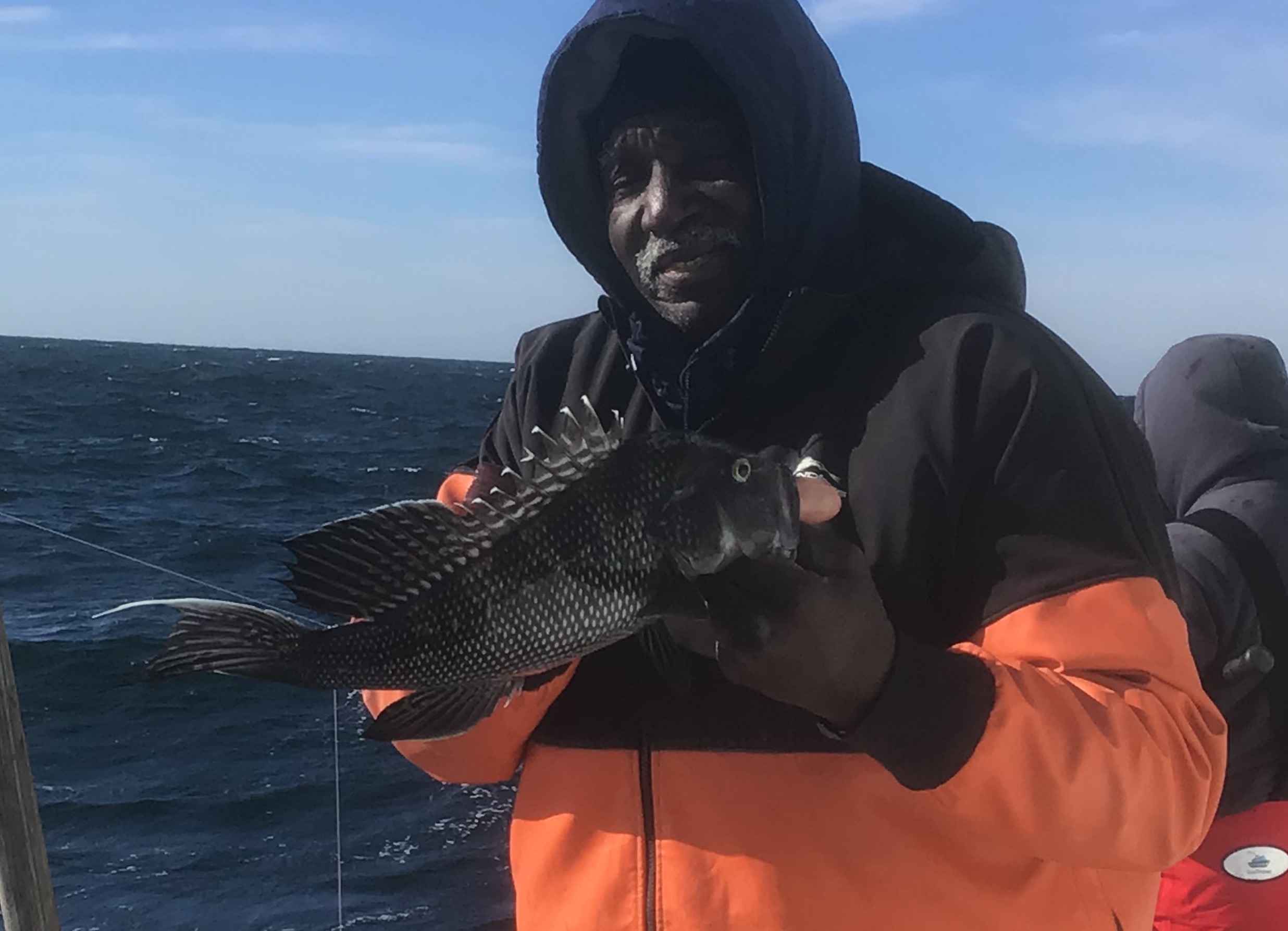 a man sitting on a boat in the water