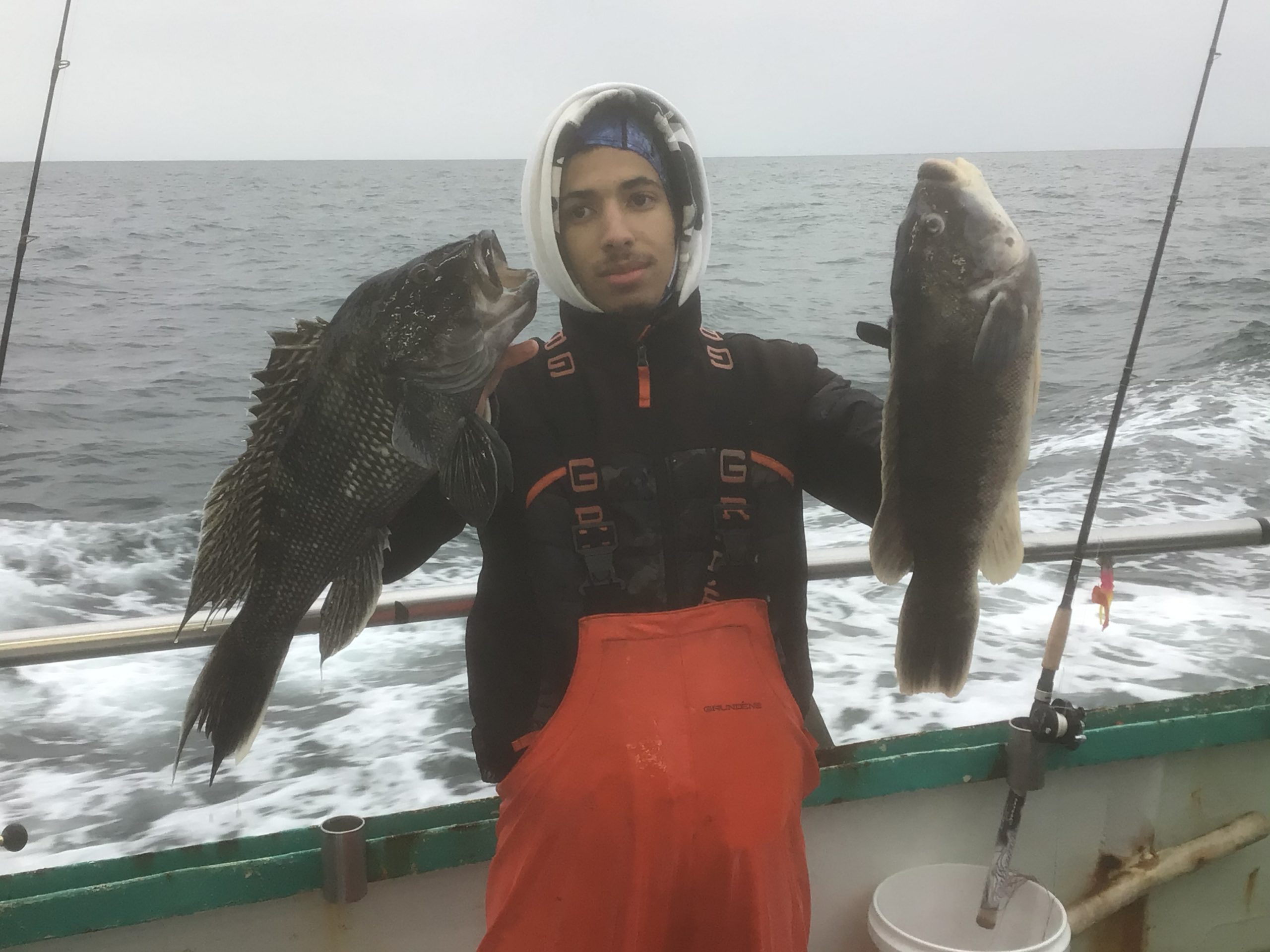 a person holding a fish on a boat in the water