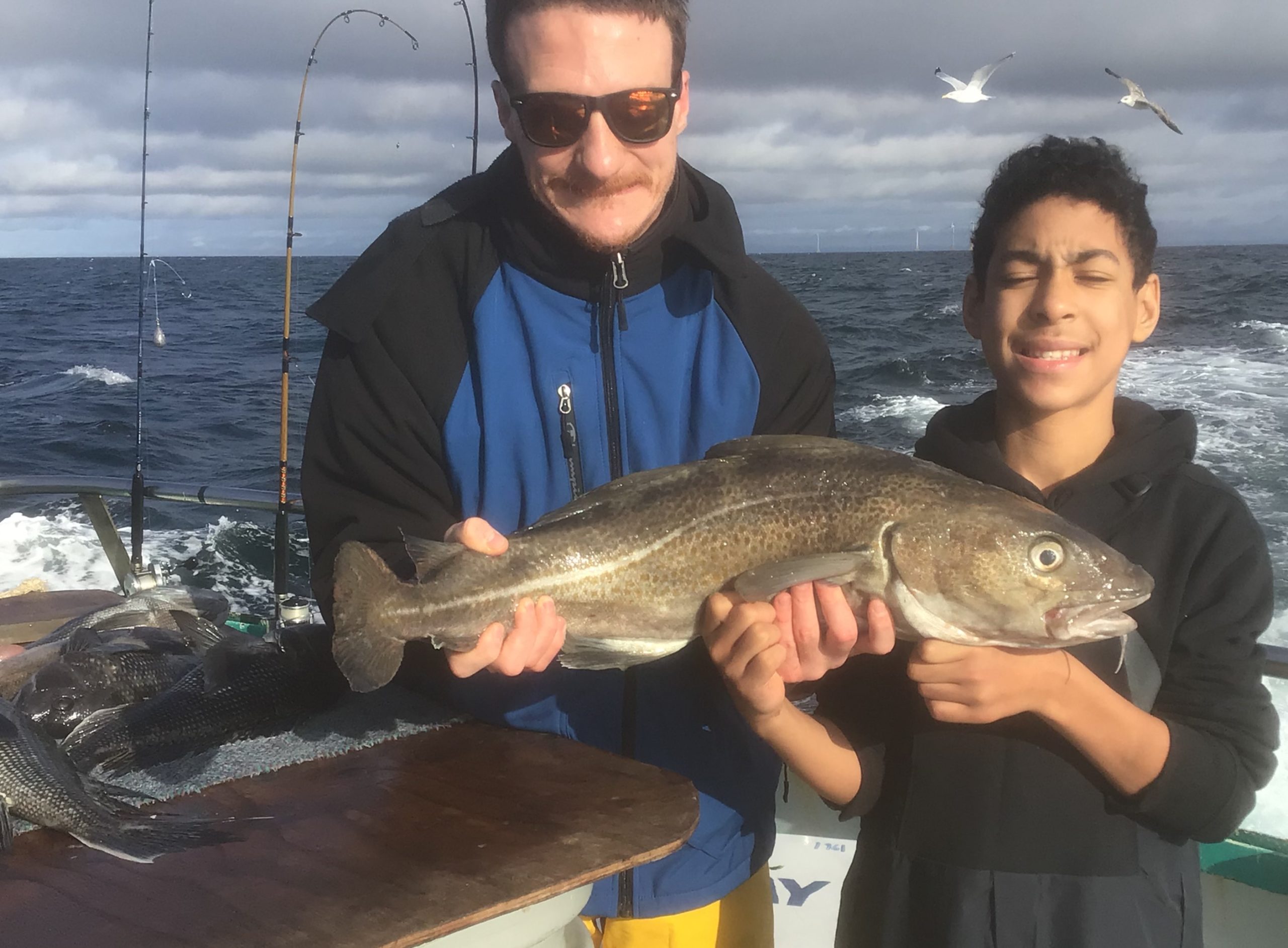 a man holding a fish in the water