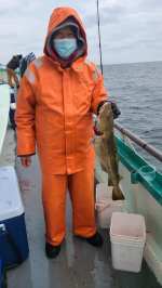 a person holding a fish in the water