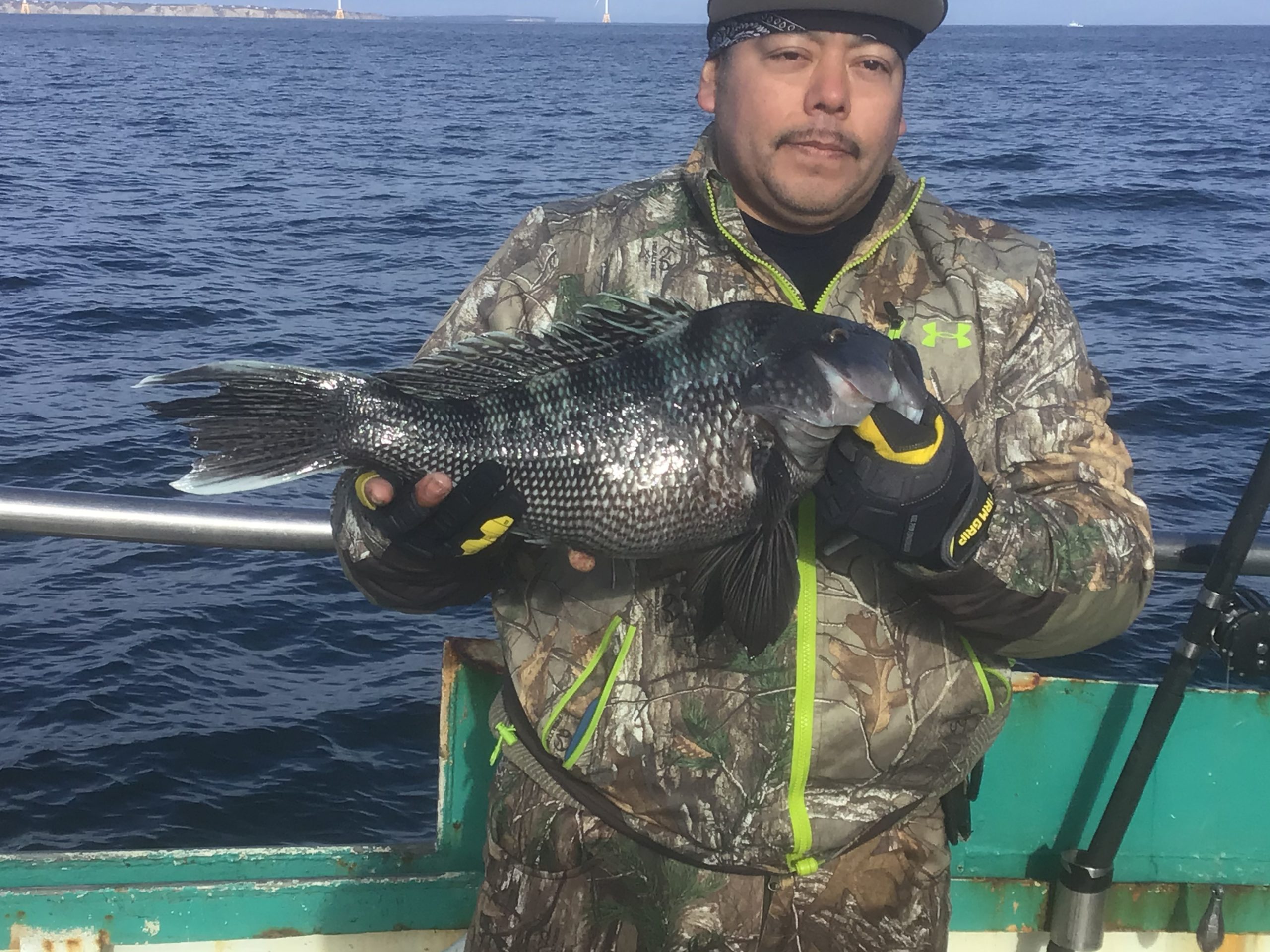 a man standing next to a body of water