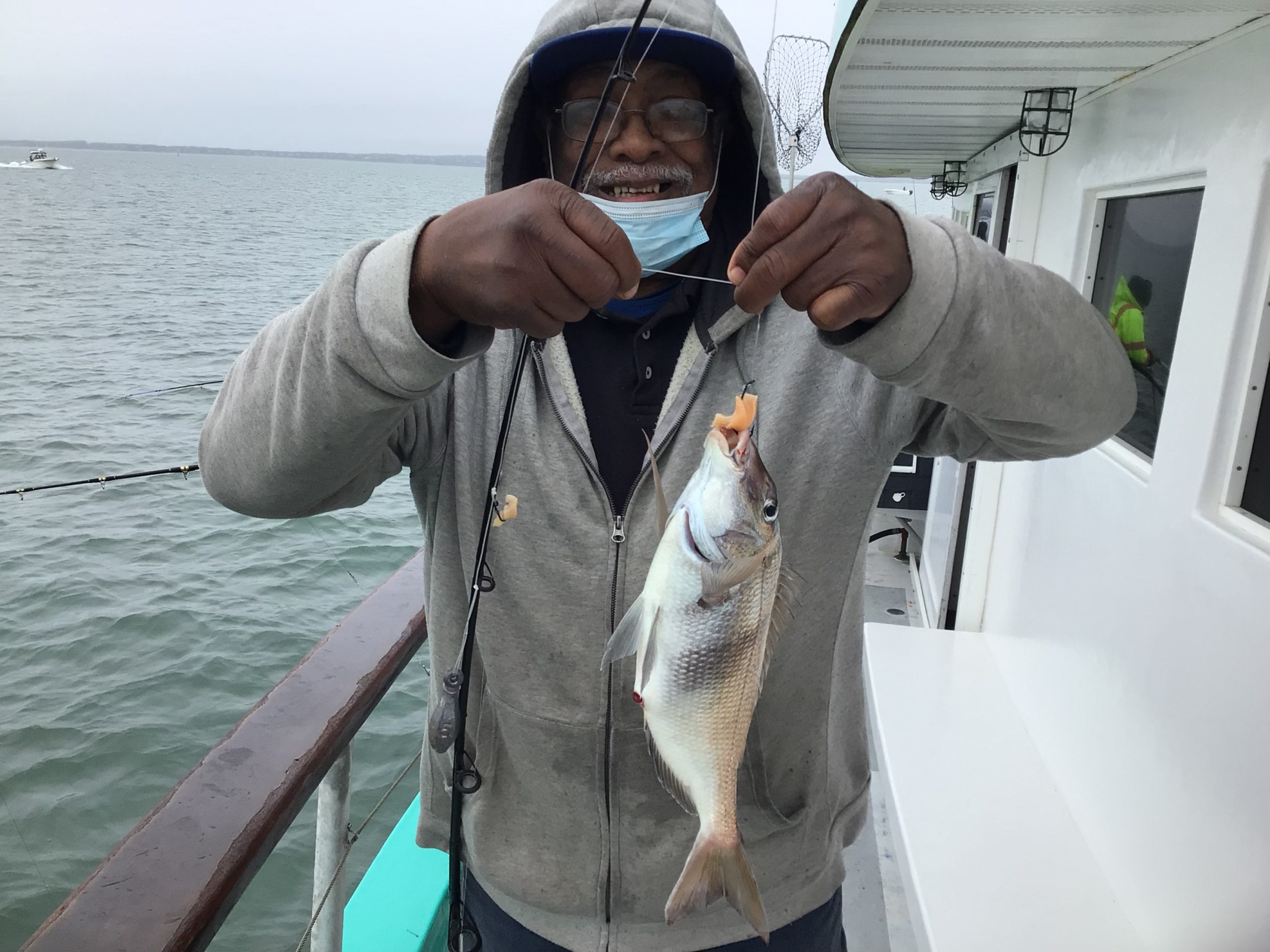 a man holding a fish in the water