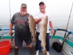 a man holding a fish on a boat posing for the camera
