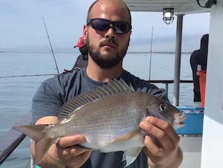 a man holding a fish