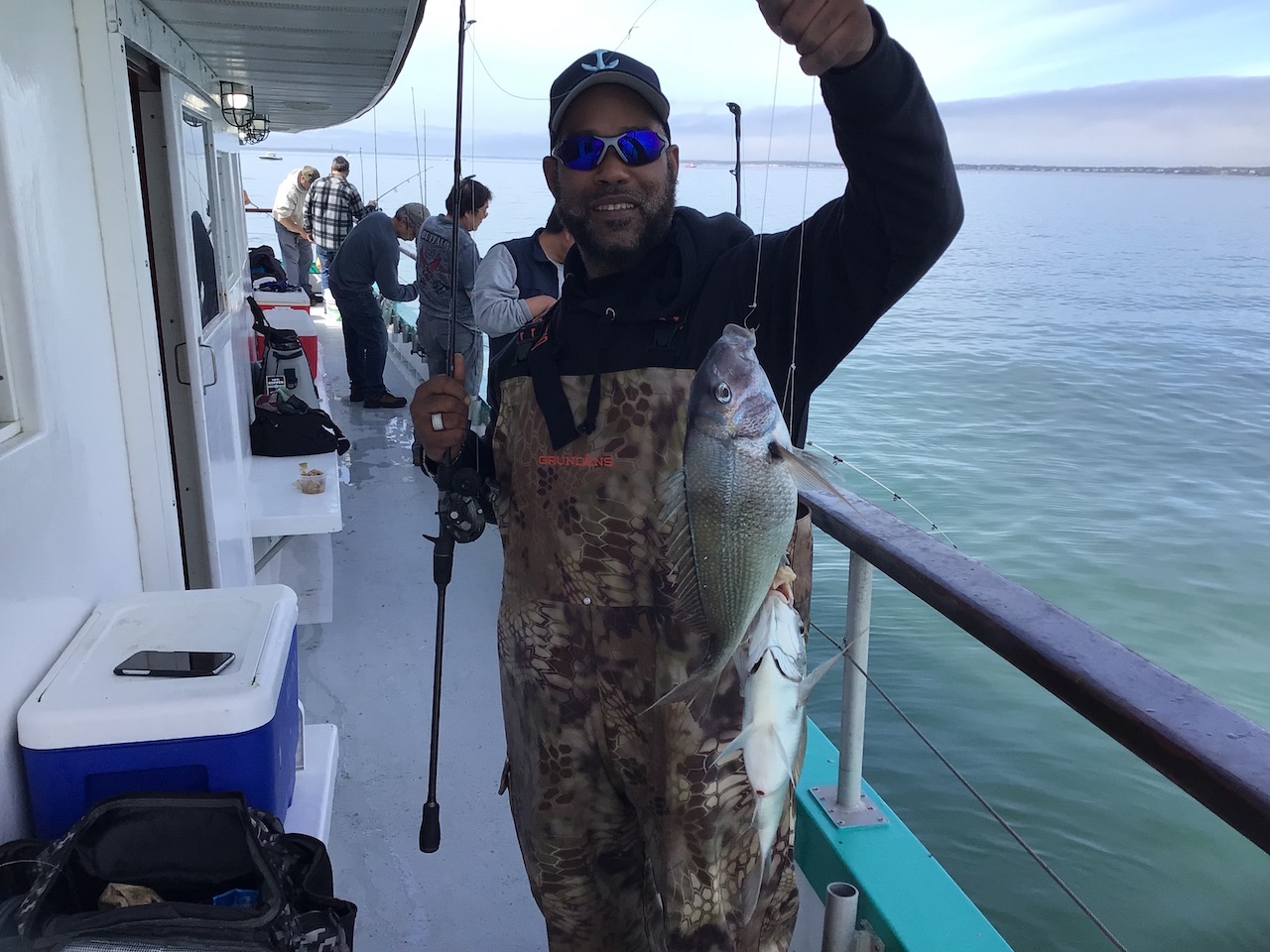 a person holding a fish in the water