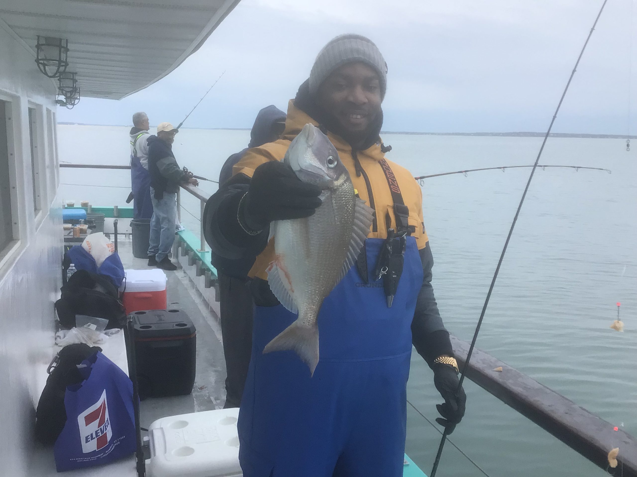 a person holding a fish on a boat