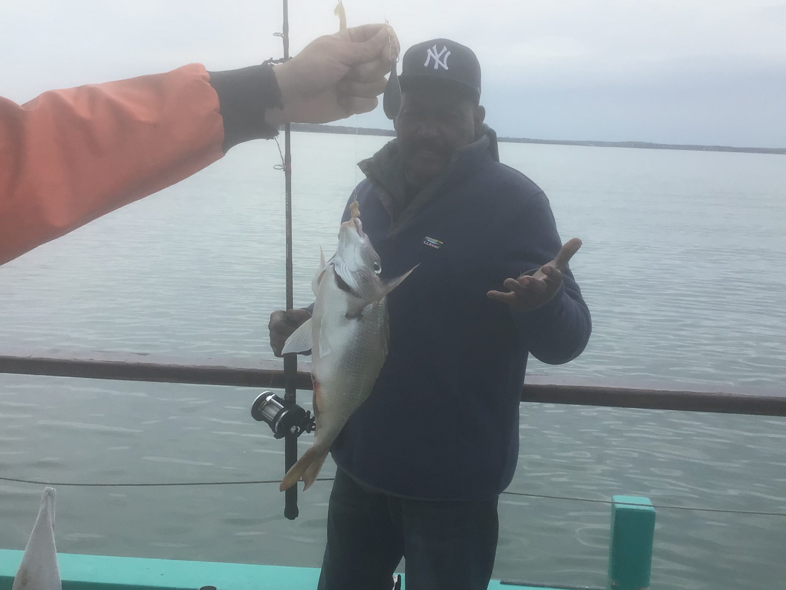 a man holding a fish in the water