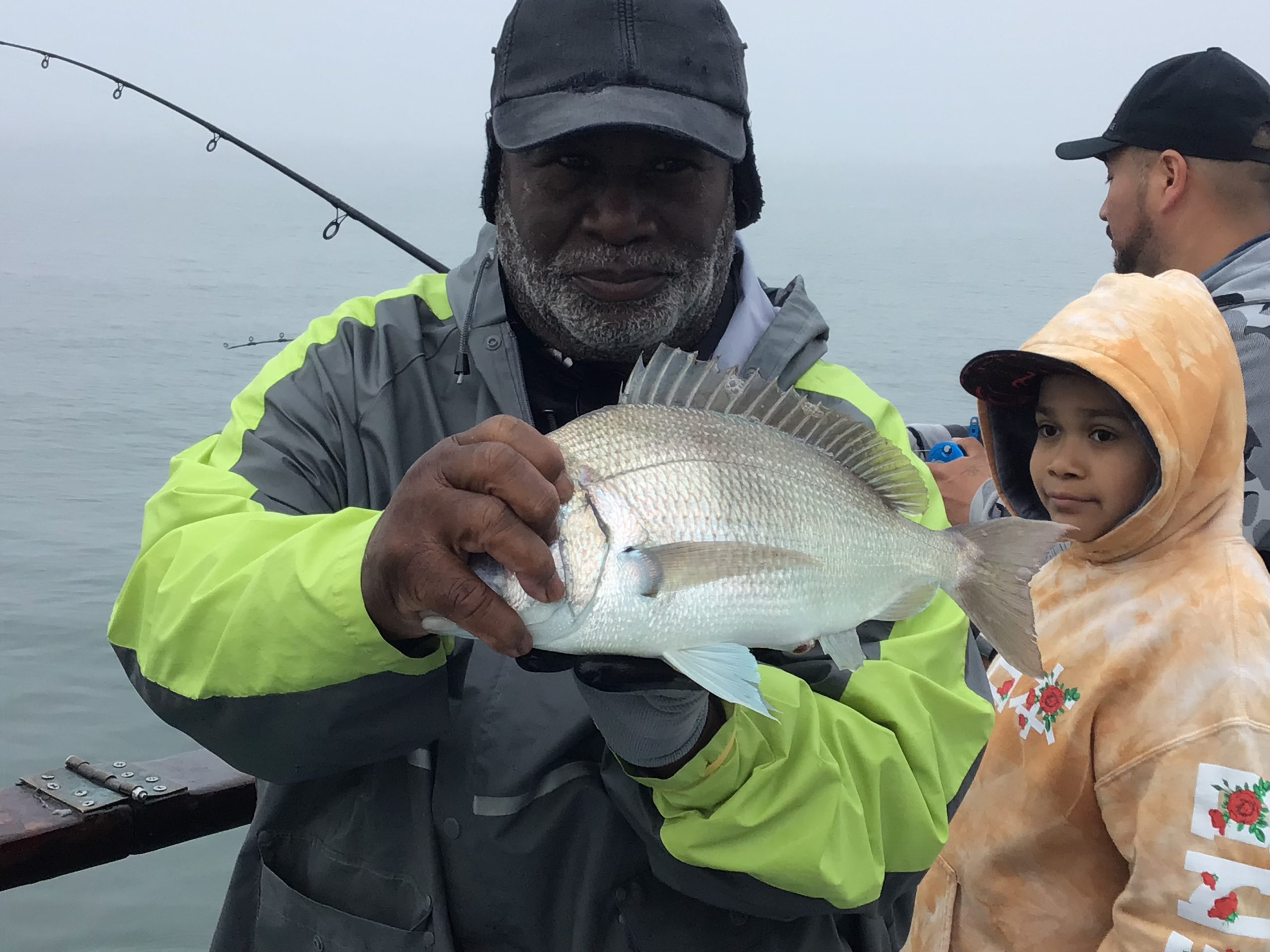 a person holding a fish in the water