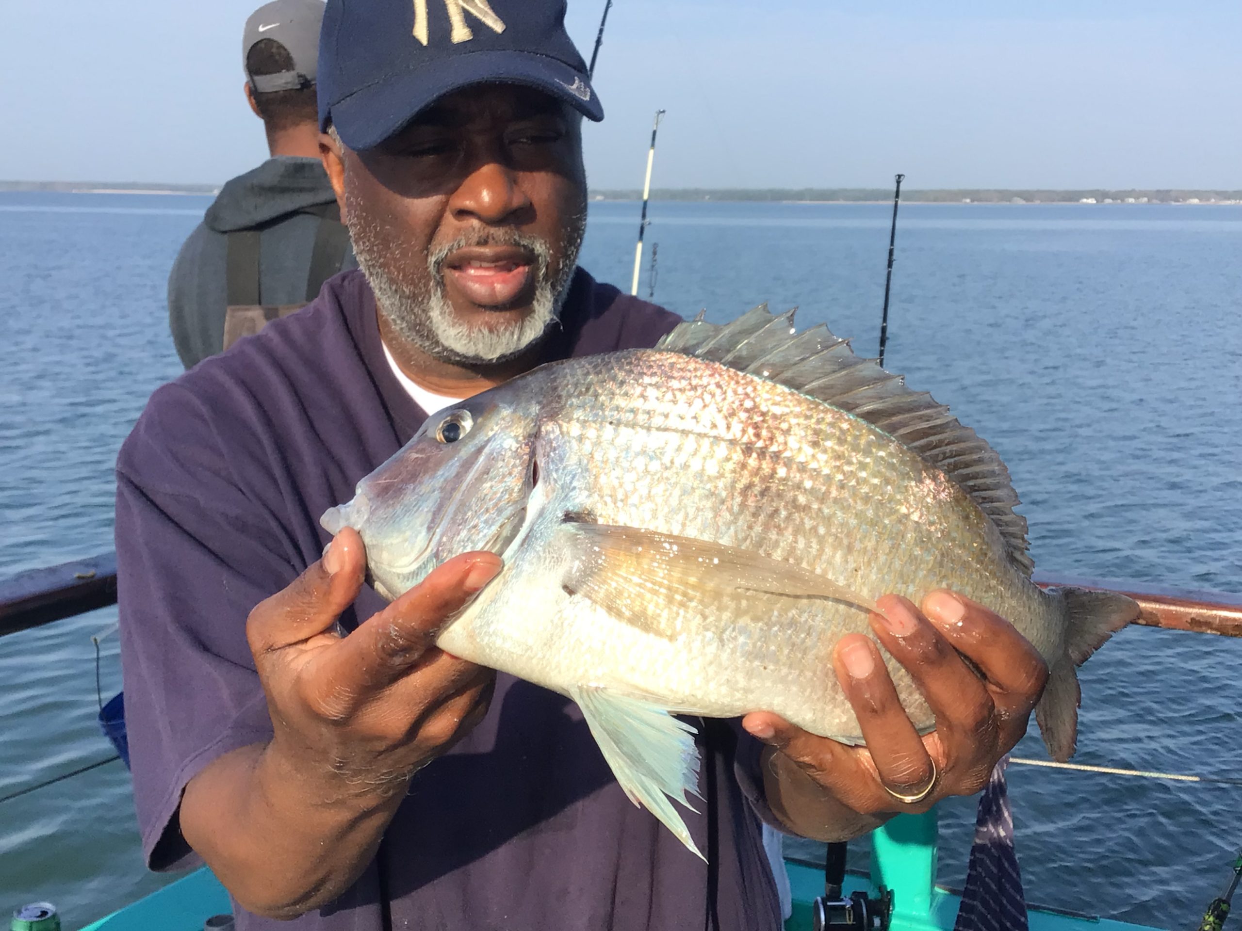 a man holding a fish in the water