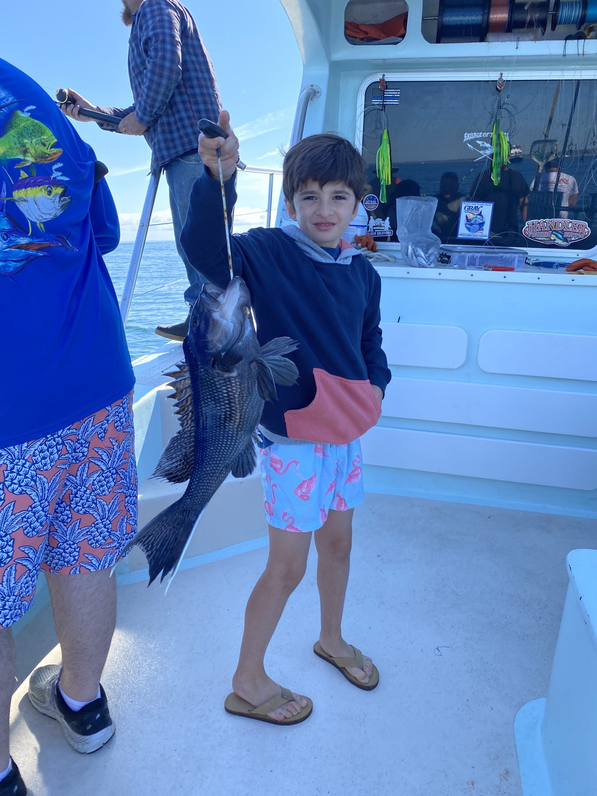 a young boy holding a blue umbrella