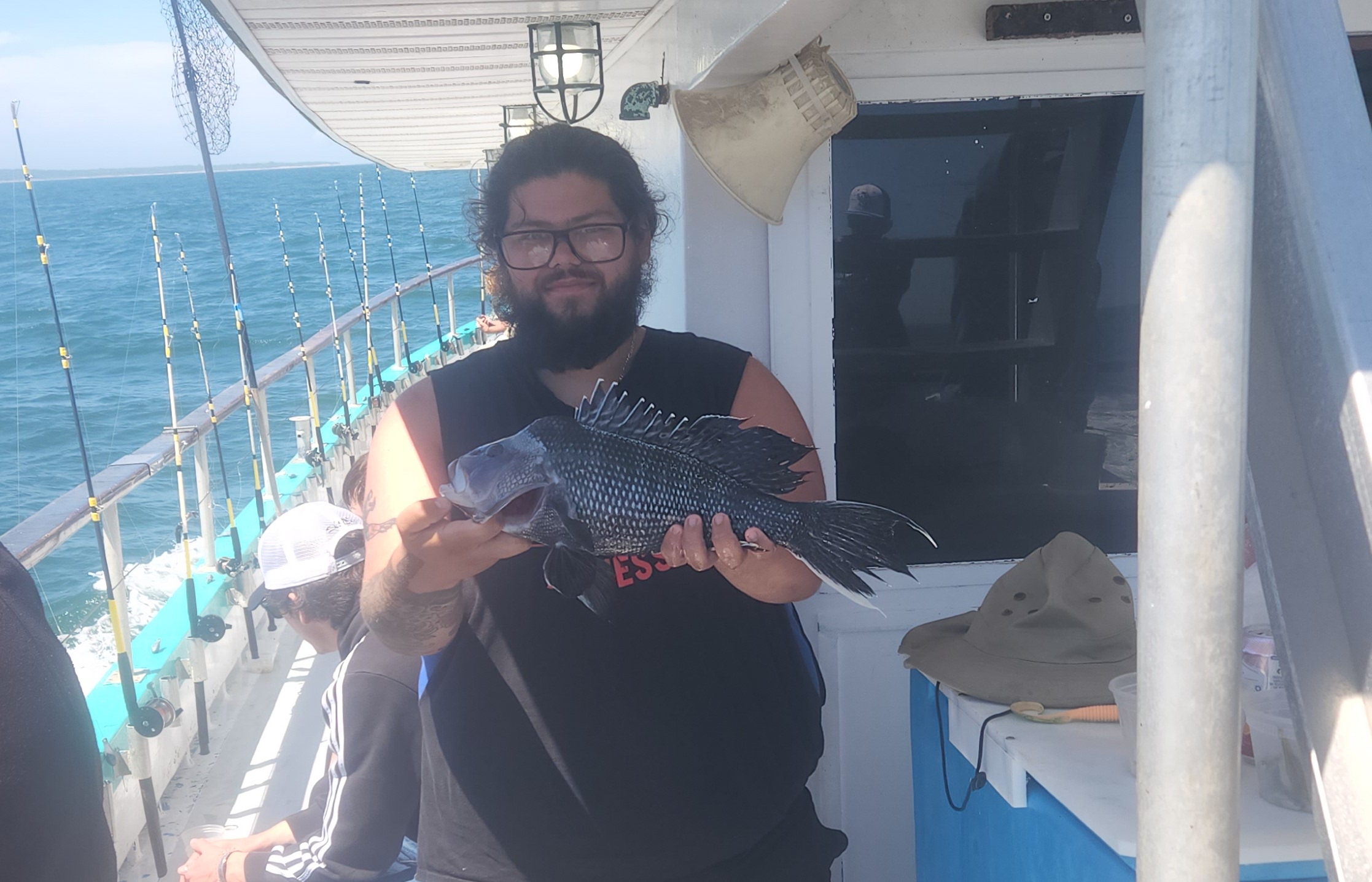 a man and a woman standing in front of a boat