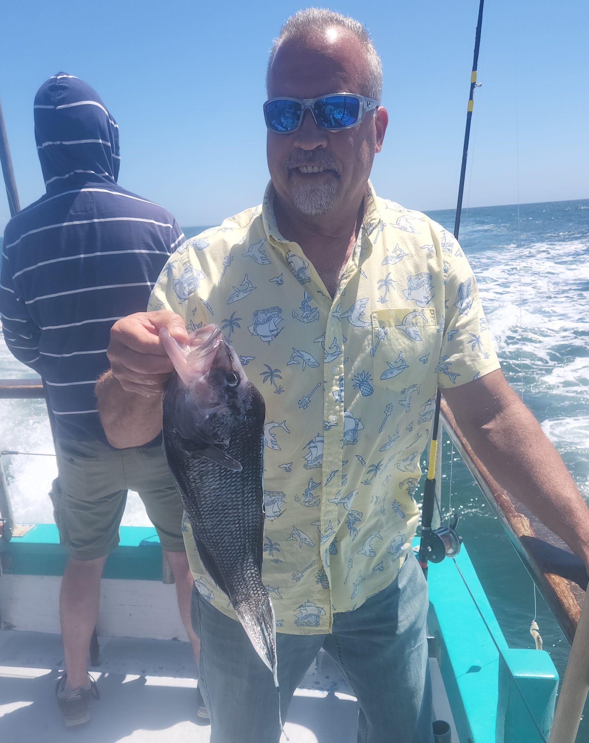 a man holding a fish