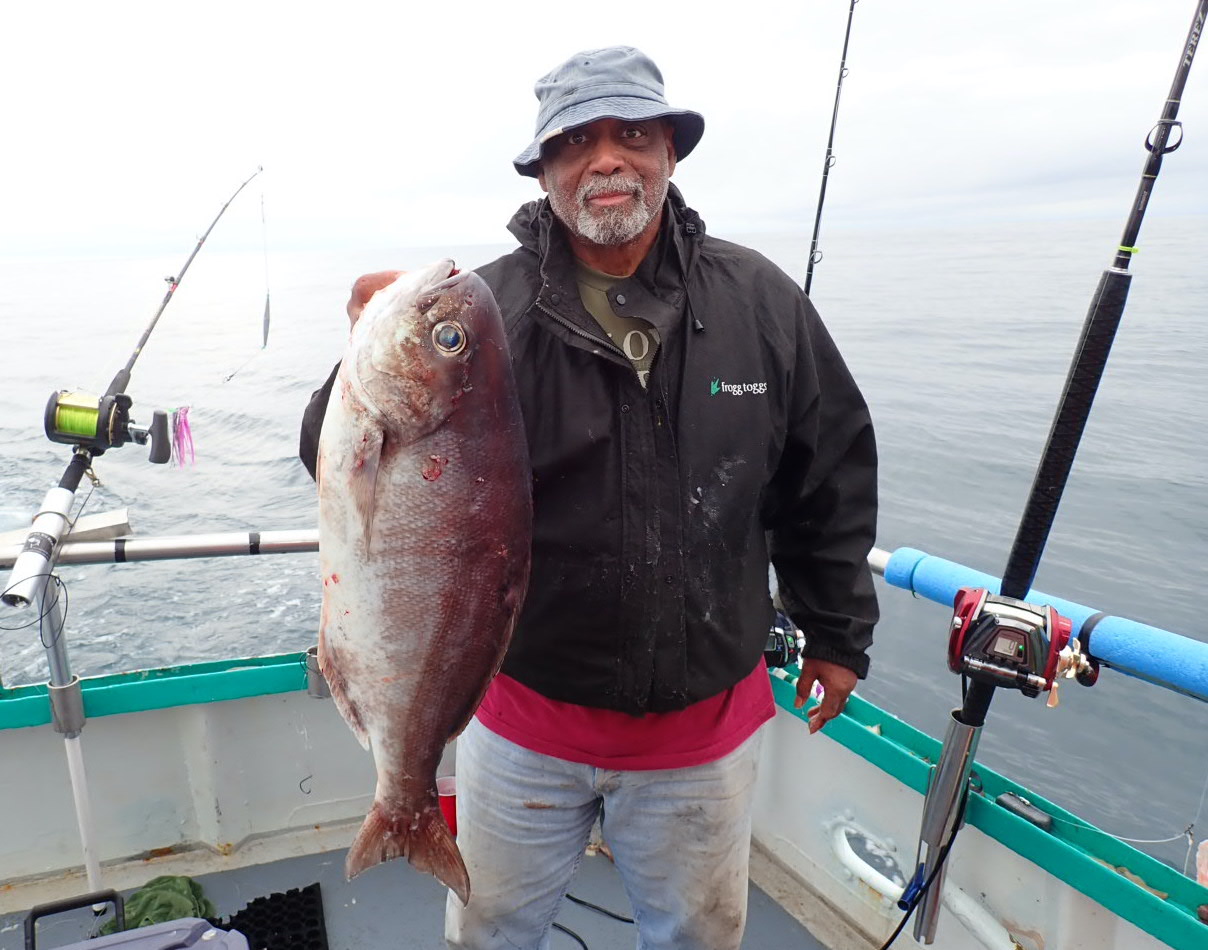 a man holding a fish in the water