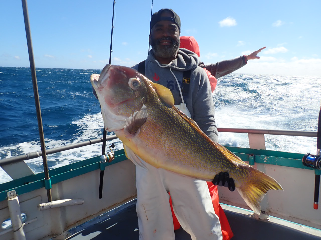 a man holding a fish in the water