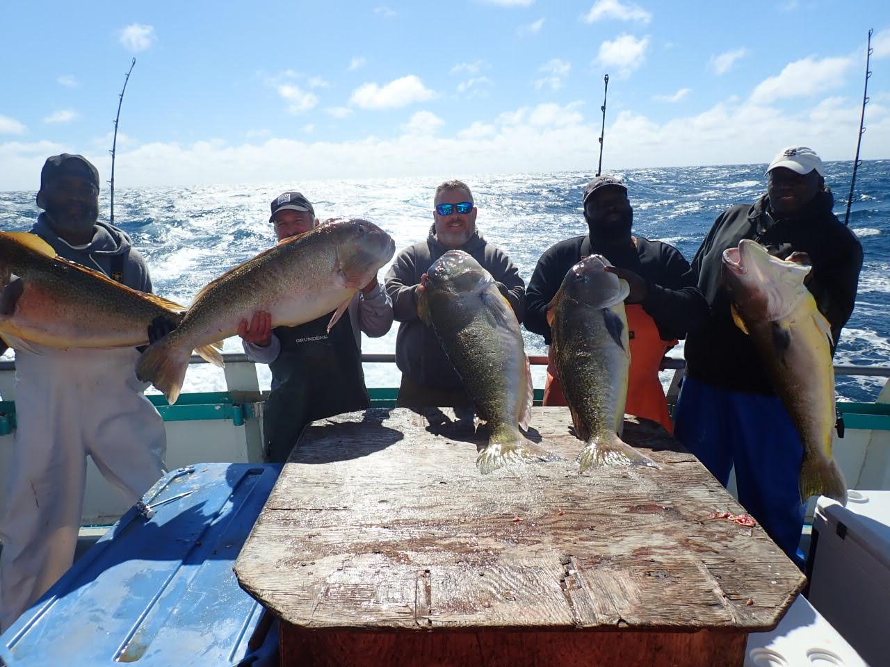 a group of people standing in front of a fish