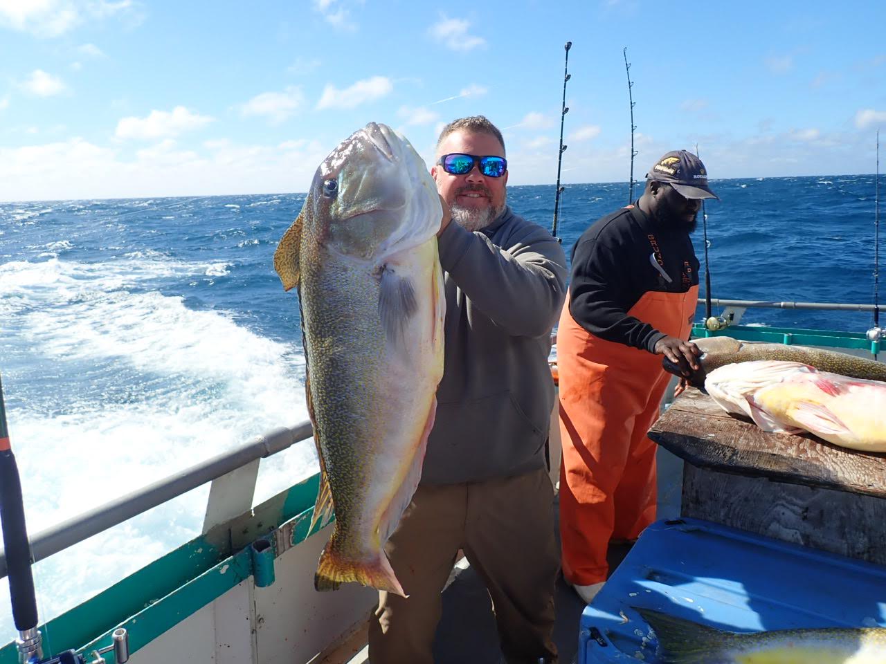 a man holding a fish in the water