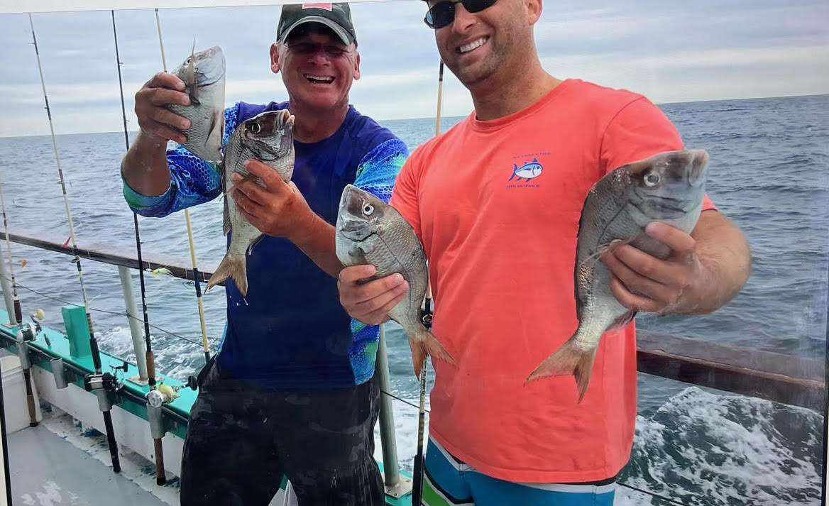 a person holding a fish in the water