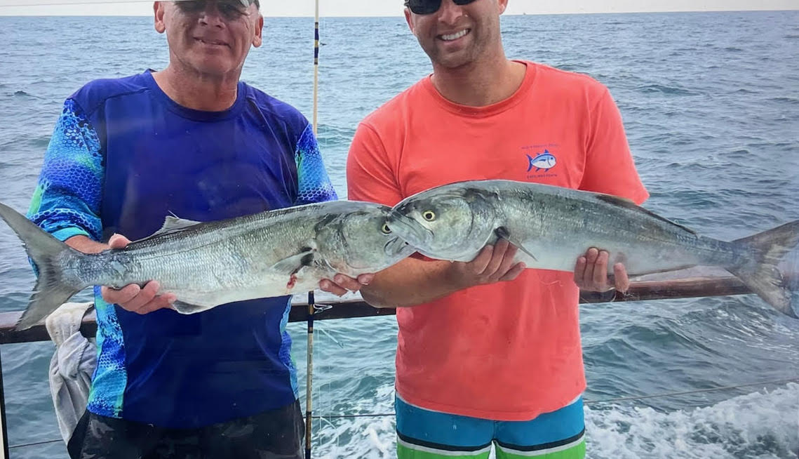 a man holding a fish in the water