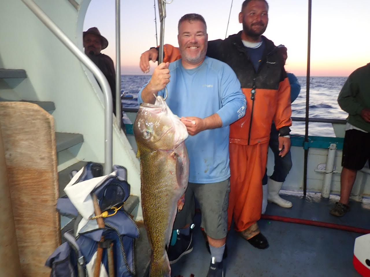 a man holding a fish