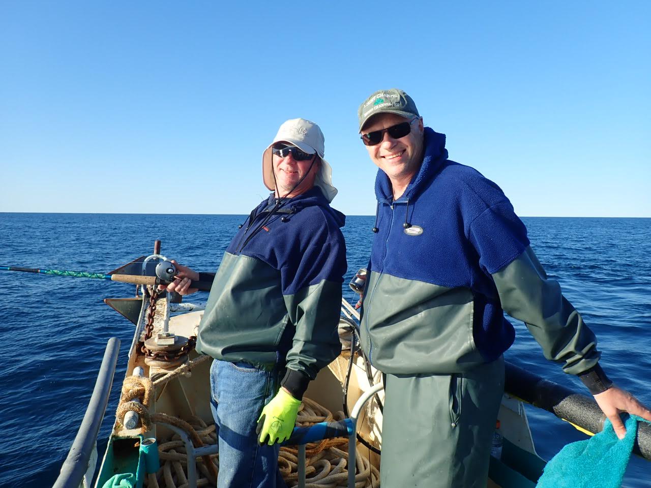 a man and a woman standing next to a body of water