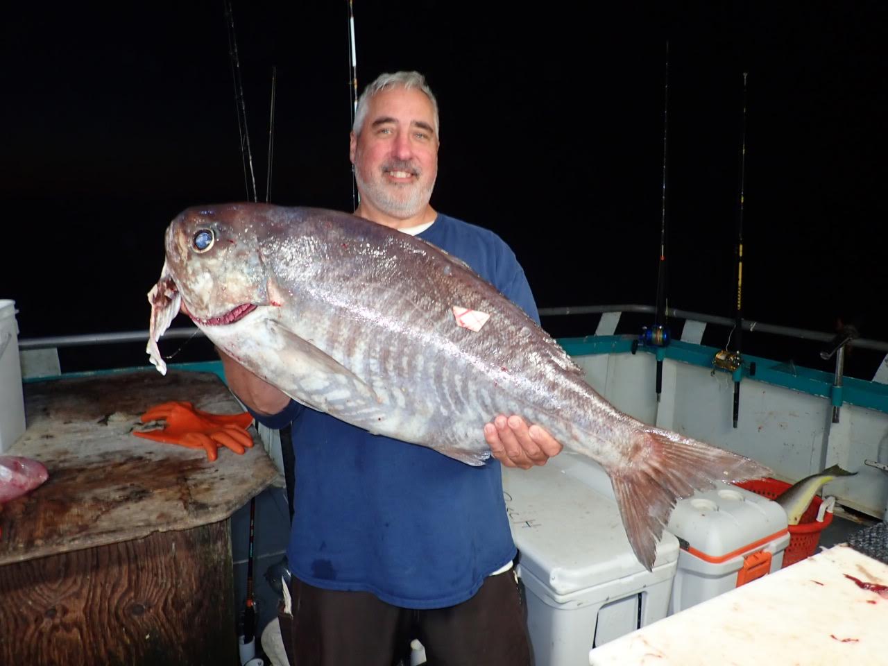 a man holding a fish