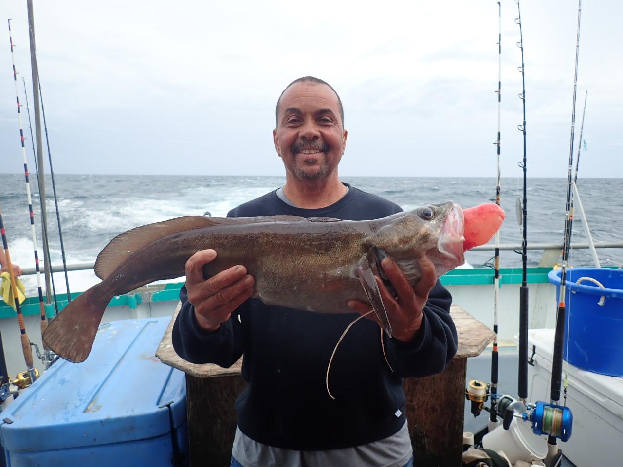 a person holding a fish in the water