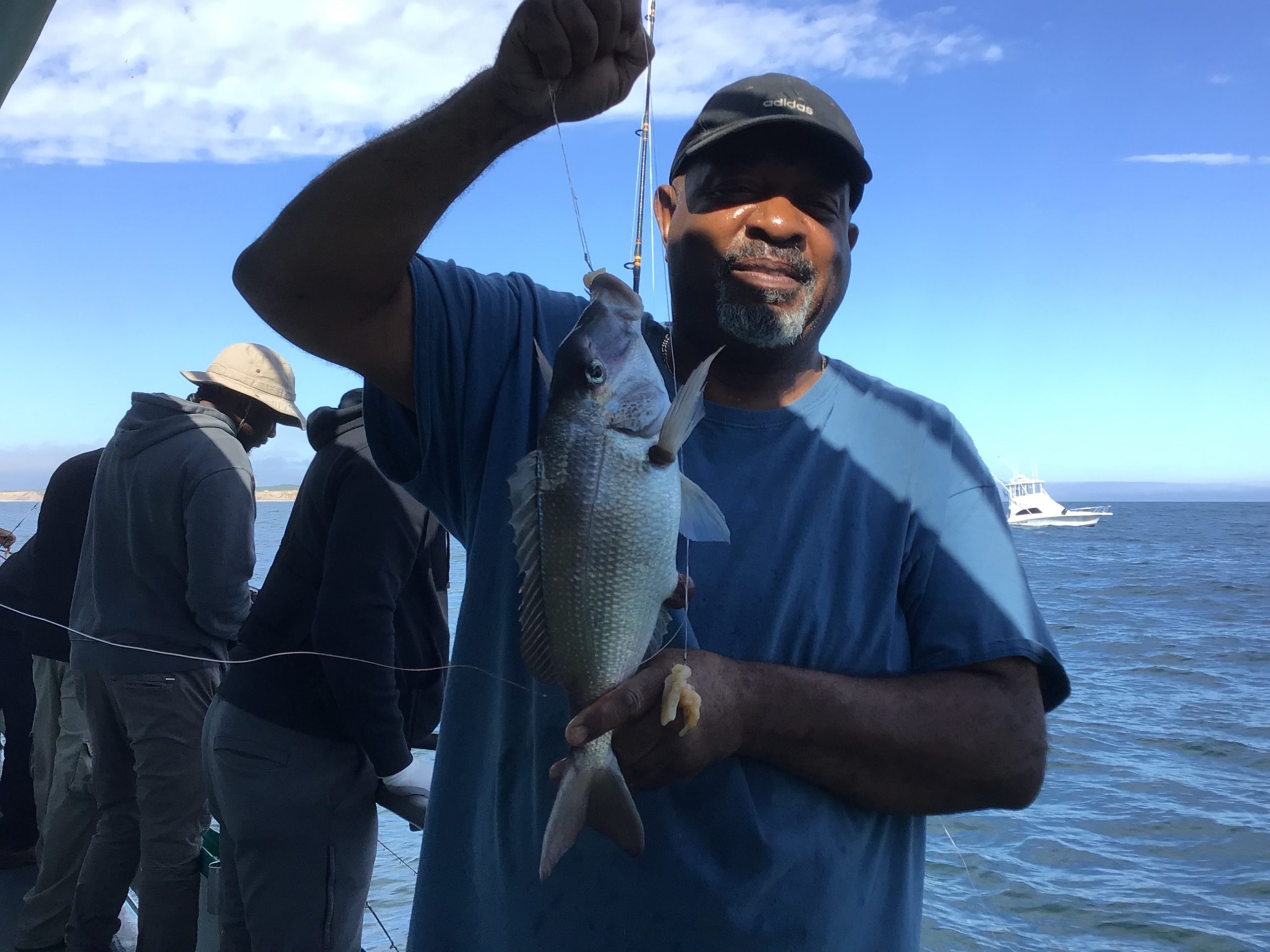 a man holding a fish in the water