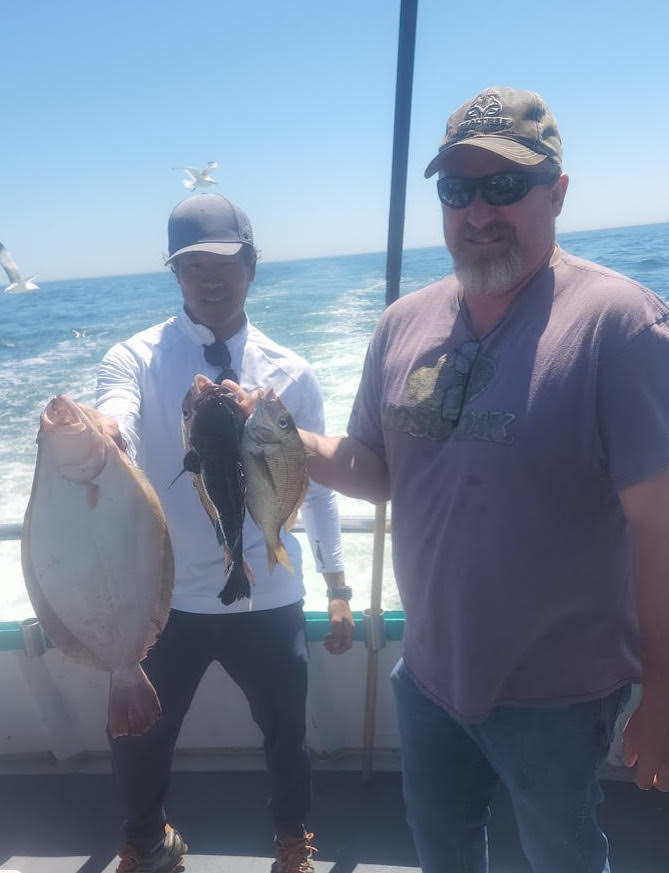 a man holding a fish in the water