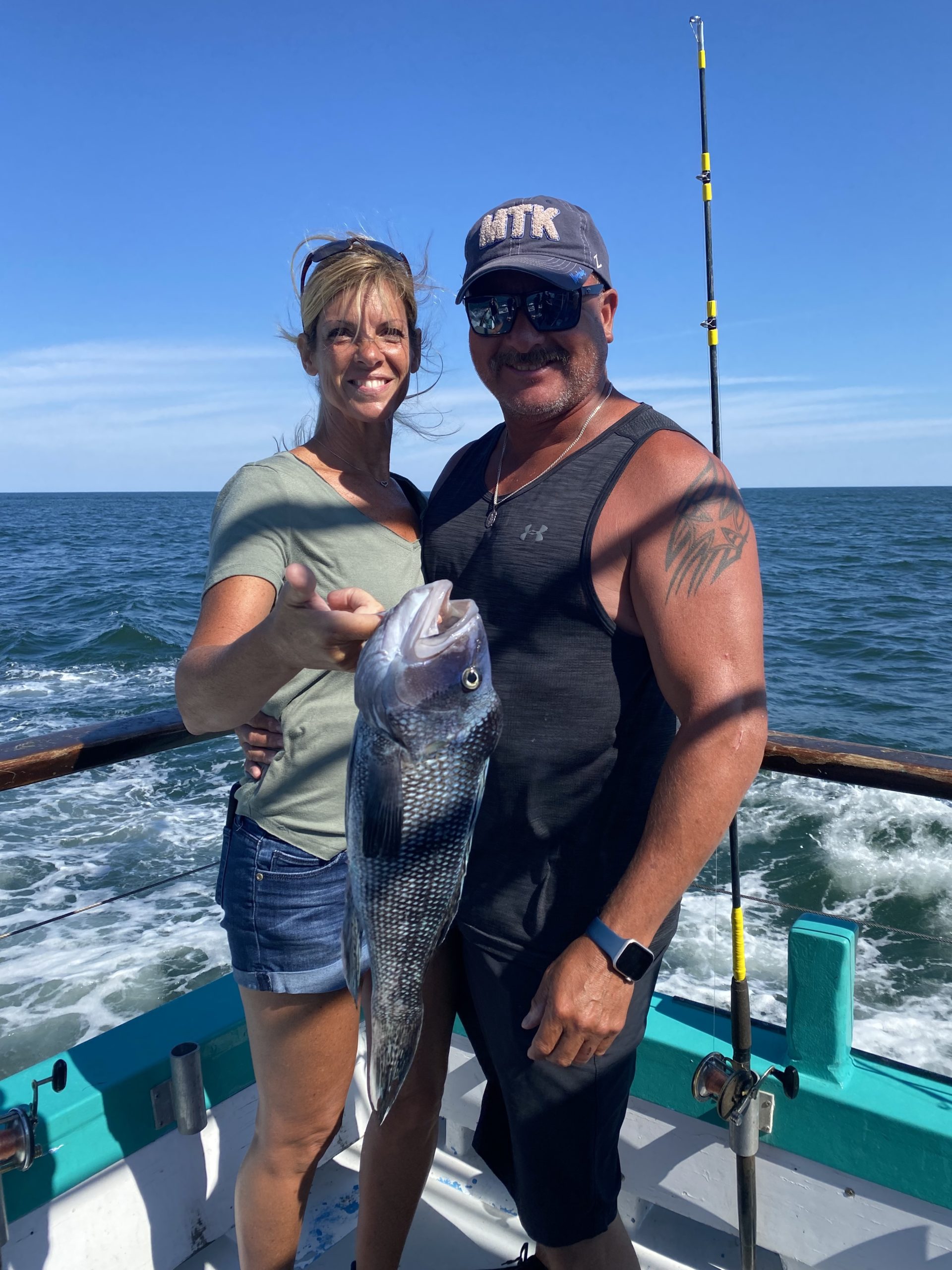 a man standing next to a body of water