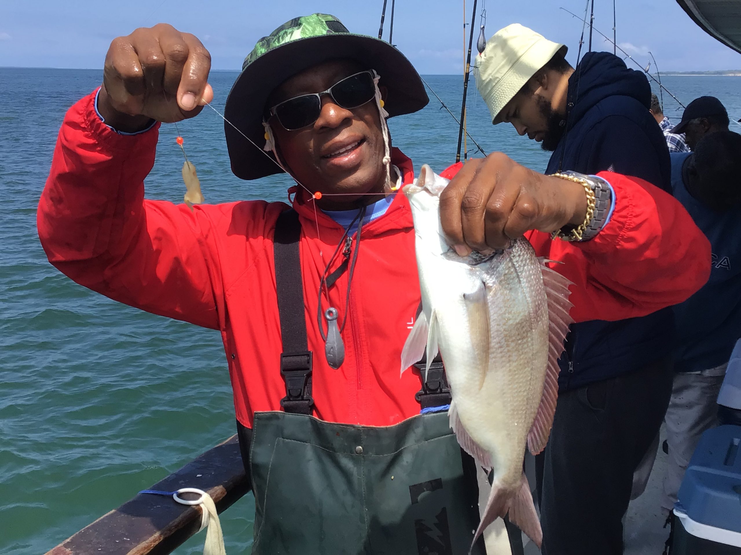 a man holding a fish in the water