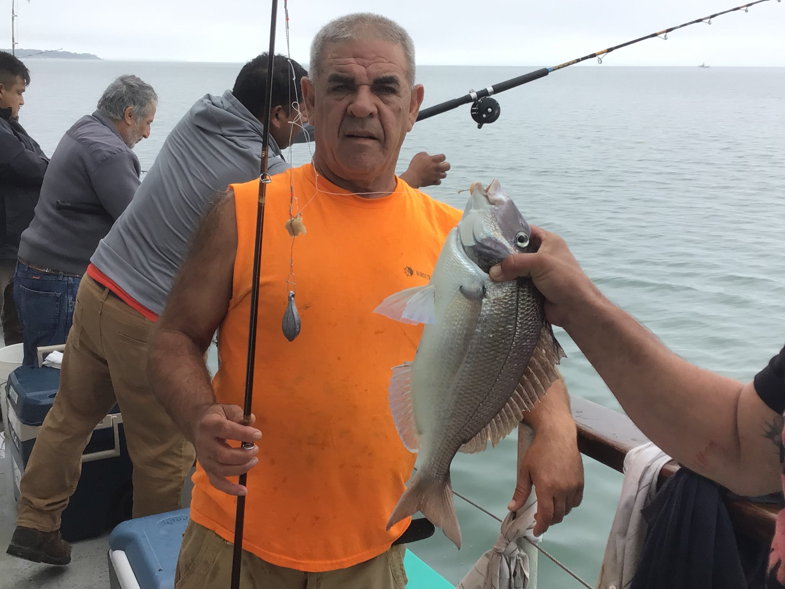 a man holding a fish in the water