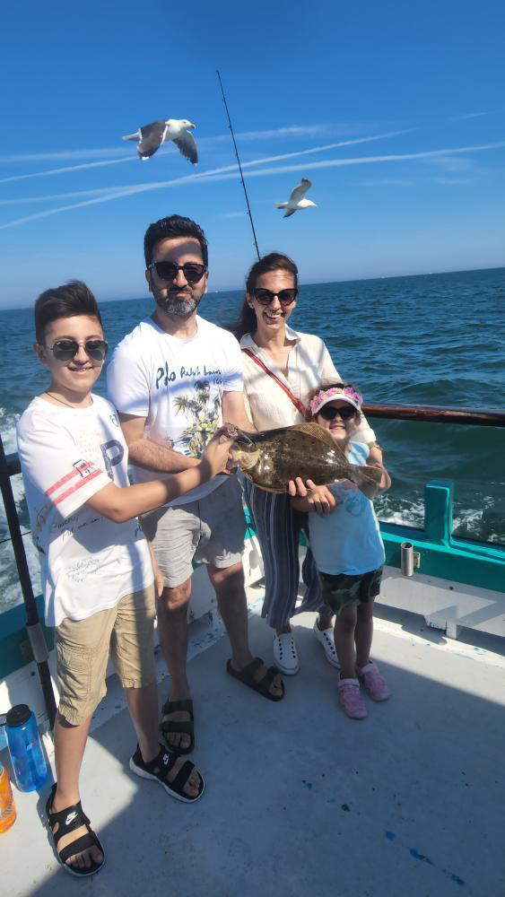 a group of people standing in front of water