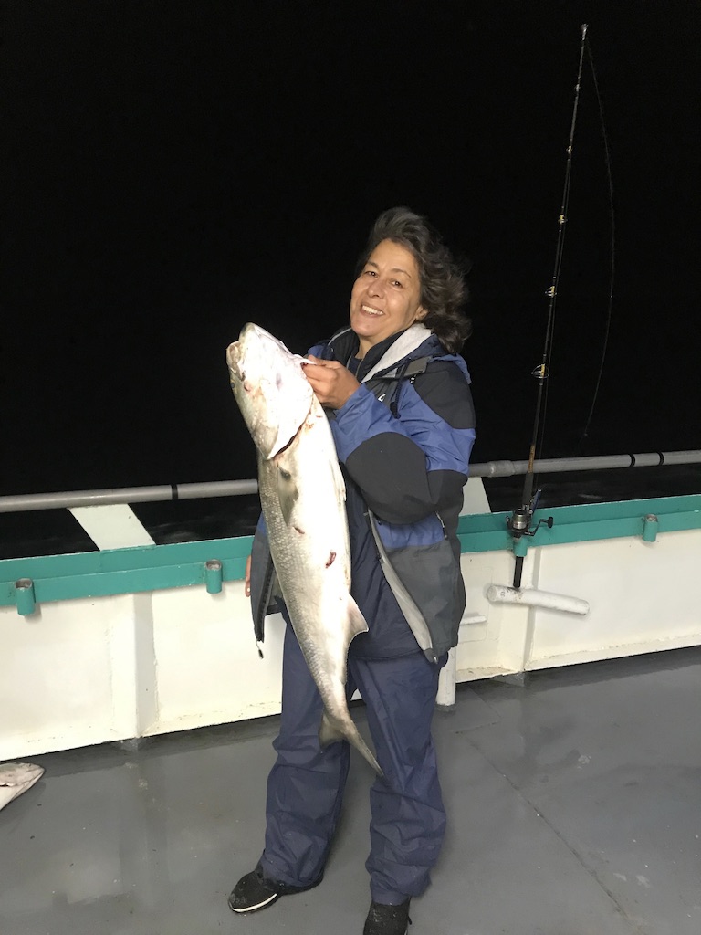 a person holding a fish